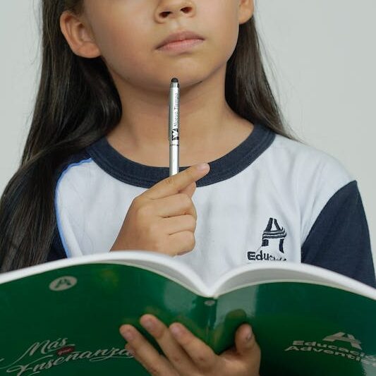 Pensive Girl with School Notebook Thinking